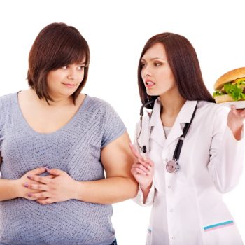 Overweight woman with hamburger and doctor.